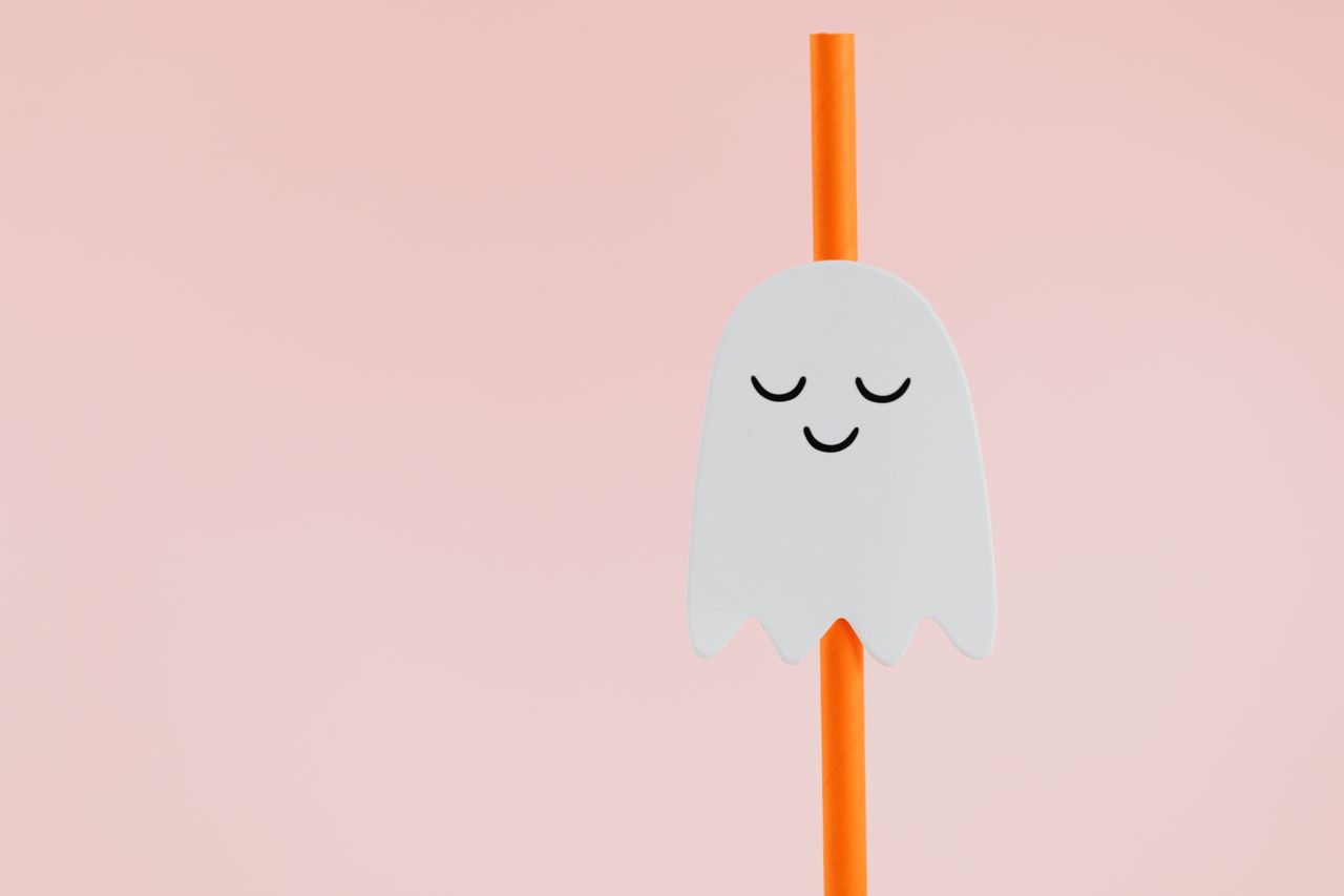 adorable paper ghost art on an orange straw perfect for a fun hallowee