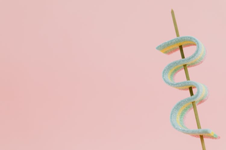 Candy On A Stick Against A Pink Background