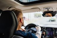 Man in Blue Jacket Driving Car