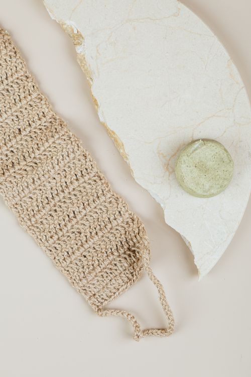 Free Close-up of a handmade loofah and natural soap on marble showcasing organic beauty products. Stock Photo