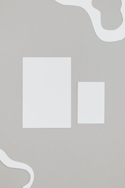 Stylish minimalist layout featuring white paper on a gray background with ample copy space. Stylish minimalist layout featuring white paper on a gray background with ample copy space.