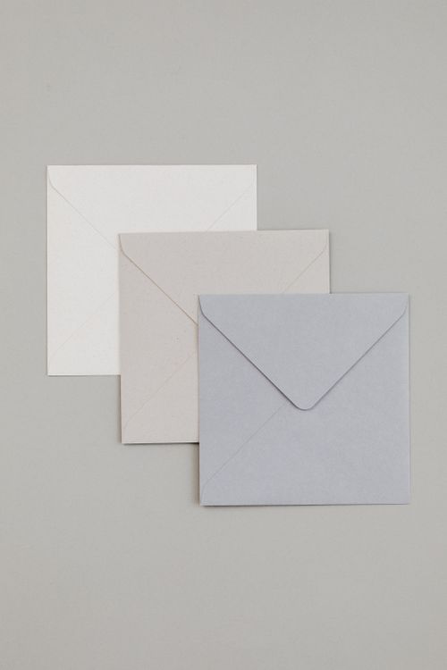 Free Minimalist arrangement of neutral toned envelopes on a gray background, perfect for stationery design. Stock Photo