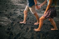 Young Couple Holding Hands On Beach