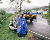 Woman in Blue Robe Standing on Road