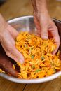 Person Holding Stainless Steel Bowl With Yellow Pasta