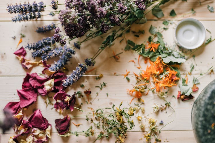 Dried Flowers And Petals On A Wooden Table