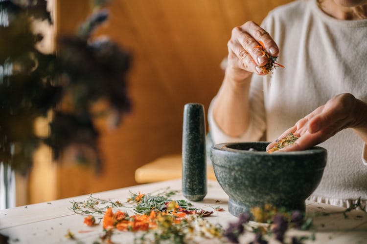 A Person Grinding Dried Flower Petals