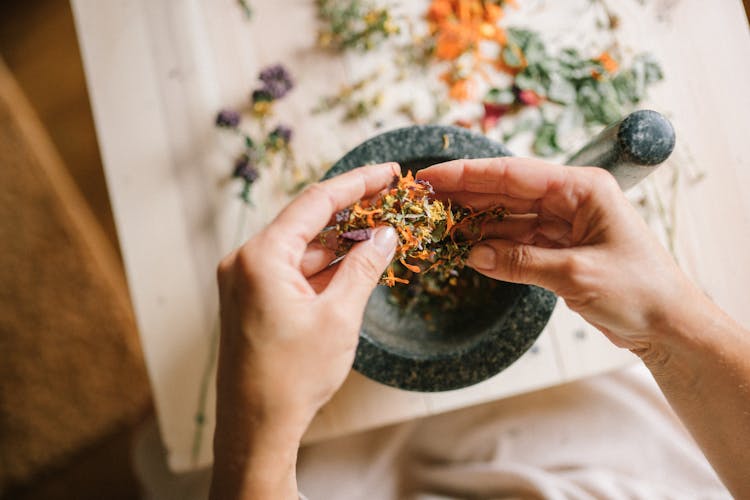 Close-up Of Woman Mixing Herbs And Spices