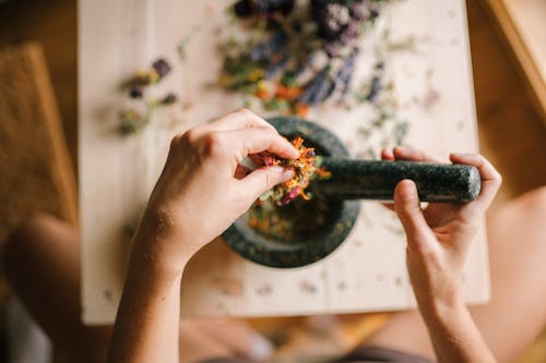 A Person Pounding Dried Flowers