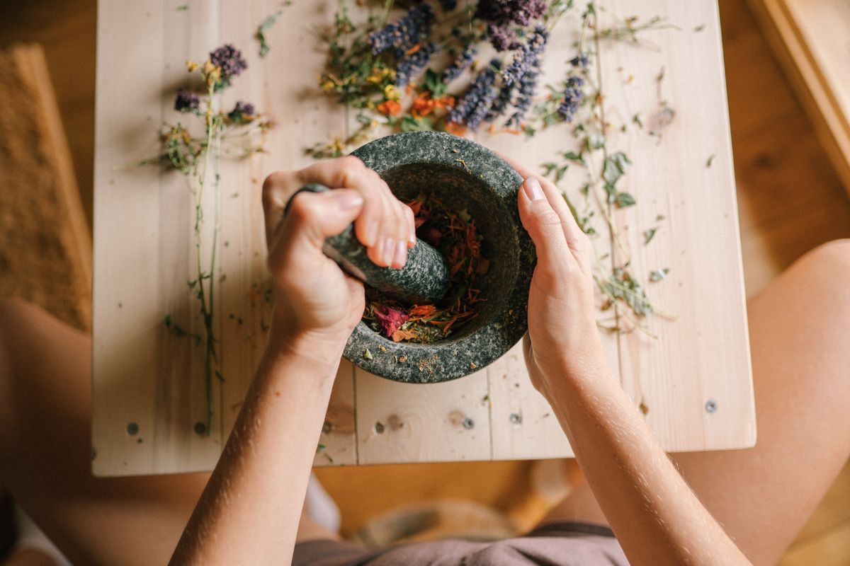 Dried flower petals being ground for pressed flower crafts tray