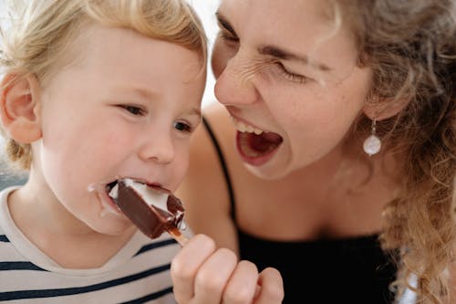 A Woman Feeding Her Son Ice Cream 