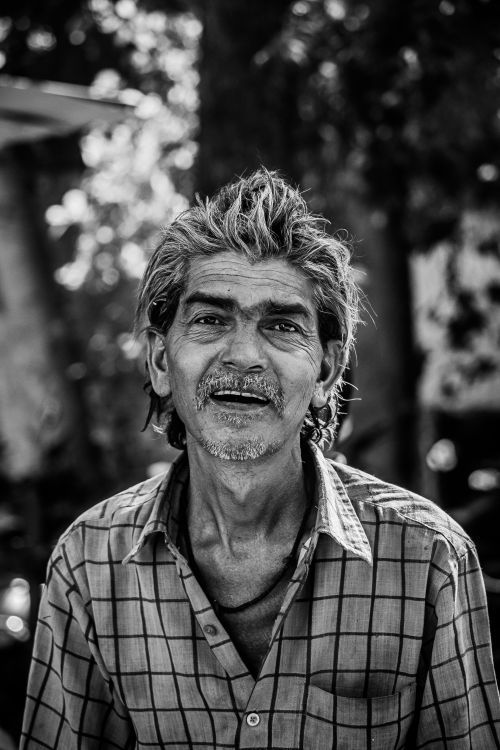 Free Emotive black and white portrait capturing the essence of an elderly man with a warm smile. Stock Photo