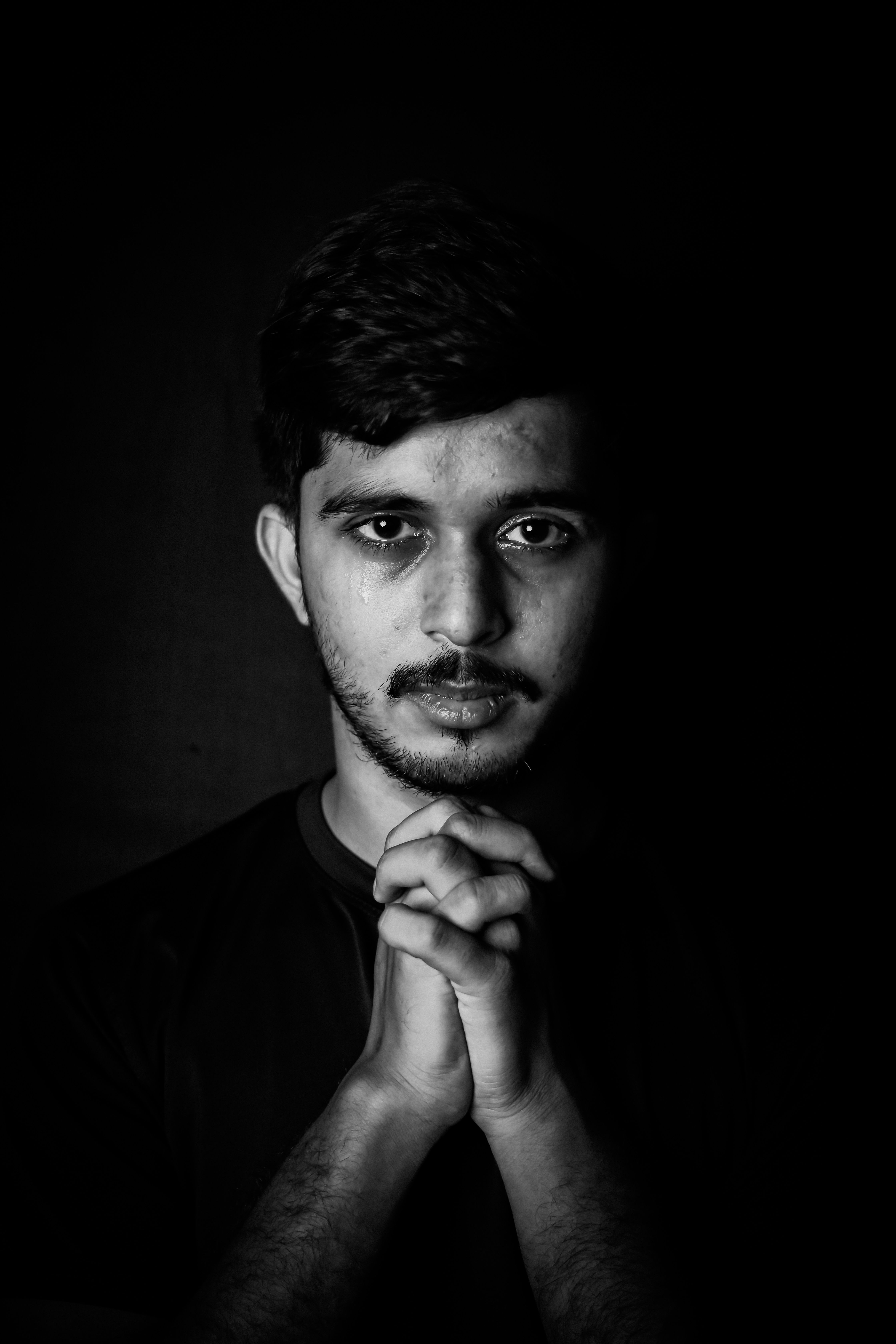 Black and White Portrait of a Man with his Hands Clasped · Free Stock Photo