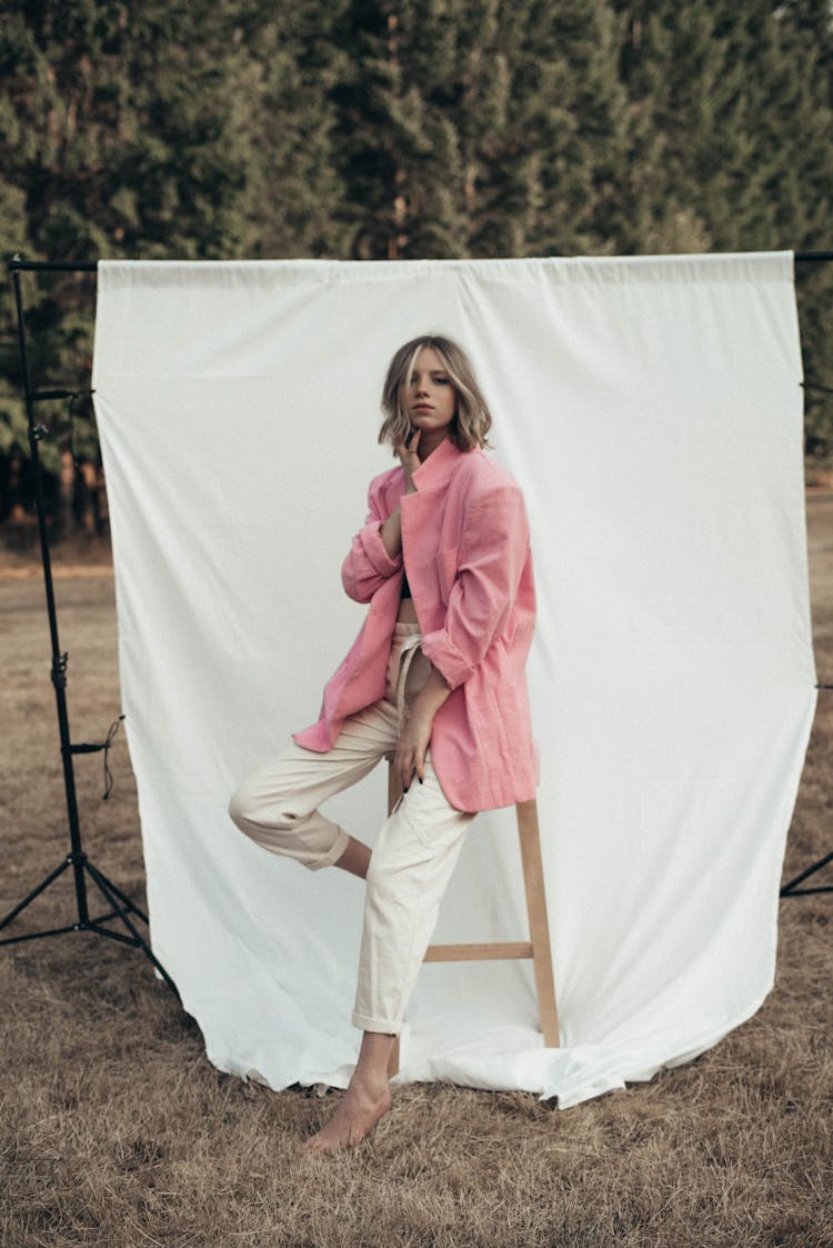 Stylish Woman Sitting On Stool