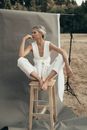 Graceful Woman Sitting on Wooden Stool