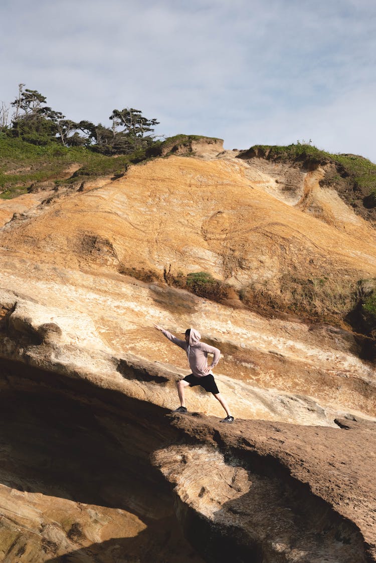 Traveler In Hero Pose On High Cliff