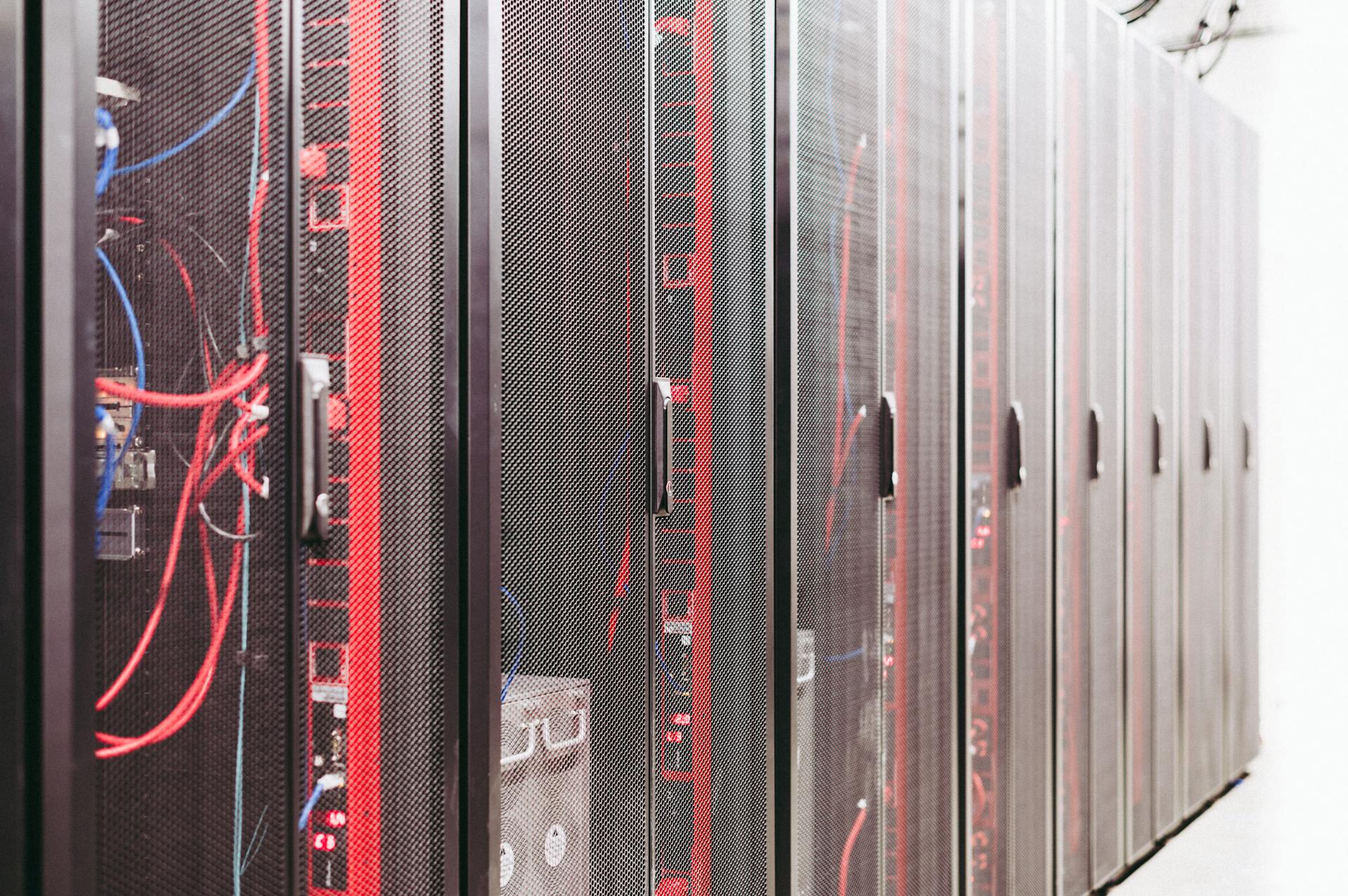 Modern data server room with network racks and cables.