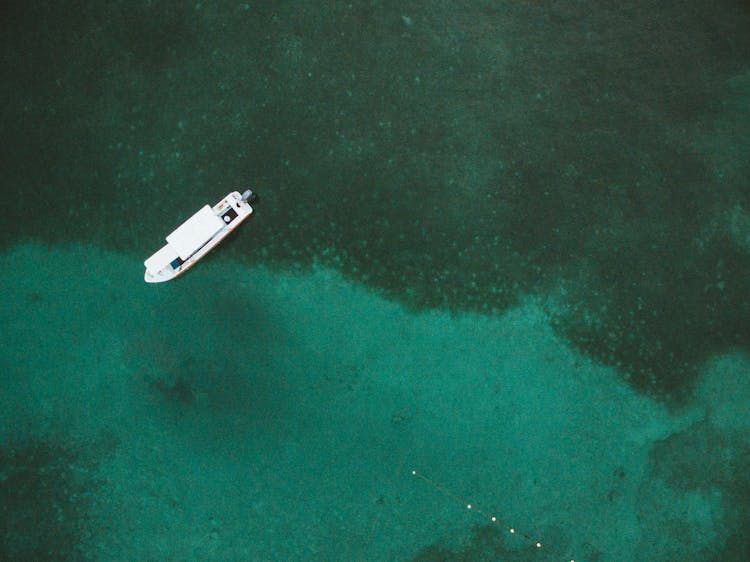 Boat Floating On Crystal Transparent Water