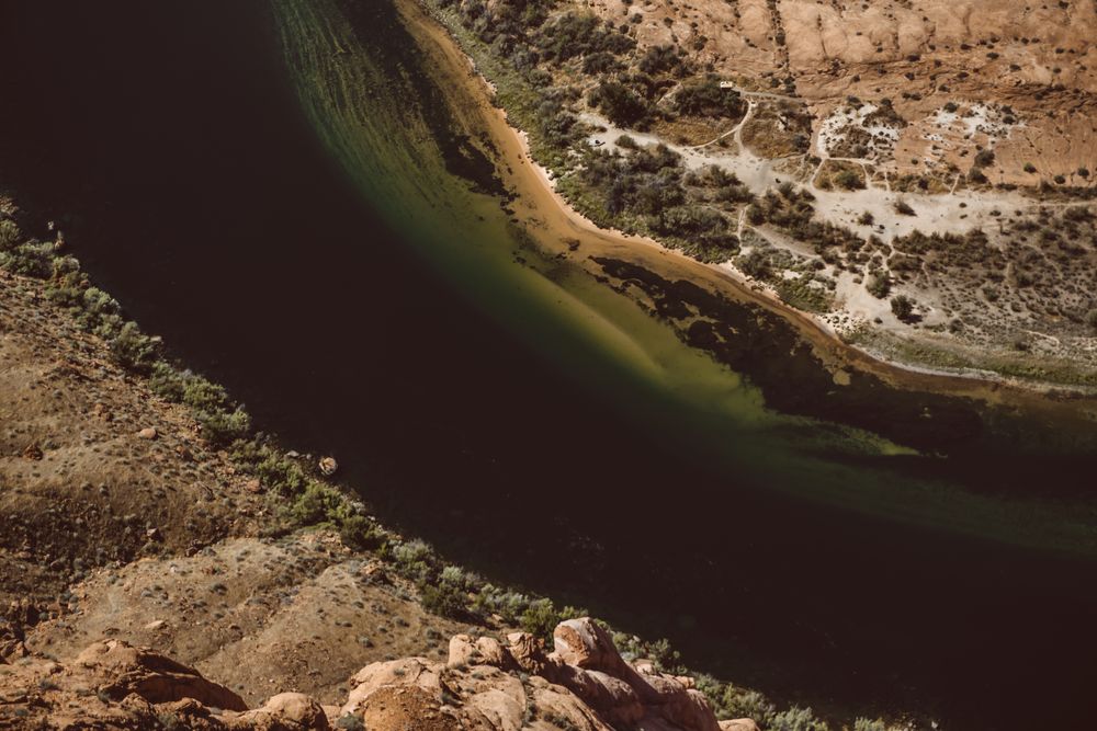 An aerial view of a river cutting through rock. Photo by Dziana Hasanbekava on Pexels