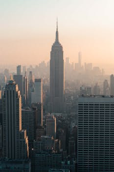 Stunning view of New York skyline featuring the Empire State Building at sunset.