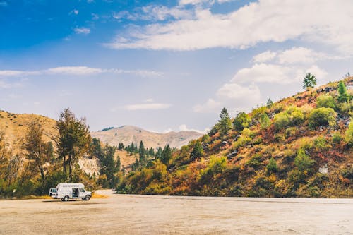 Free Camper Van Parked In Hilly Scenery Stock Photo