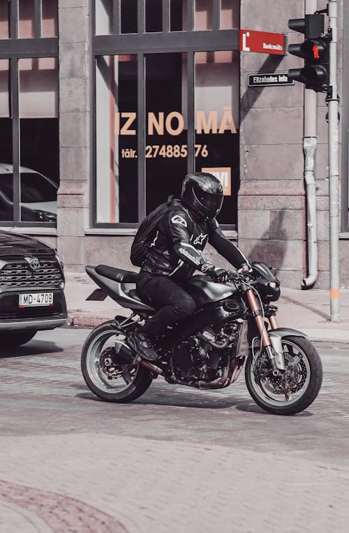 Man in Black Leather Jacket Riding Black Motorcycle