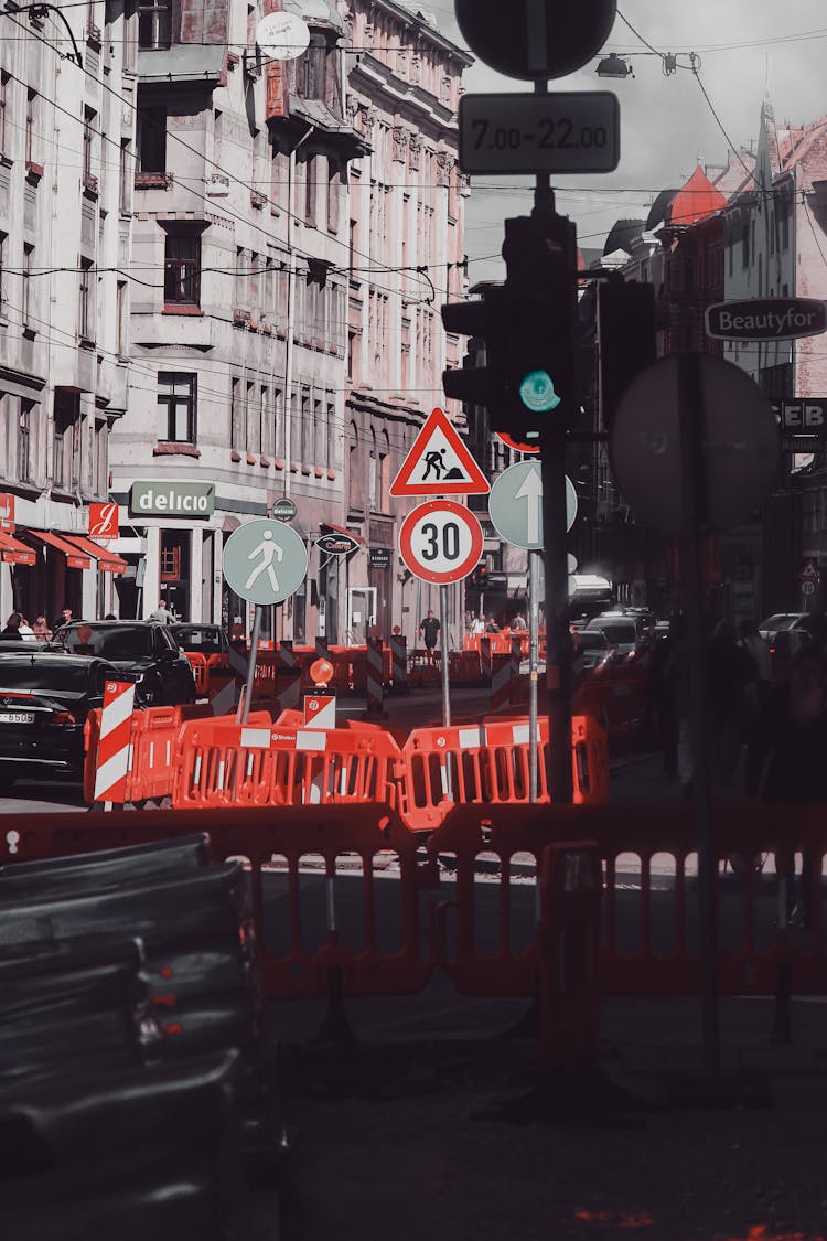 Red Road Barriers Beside Concrete Buildings