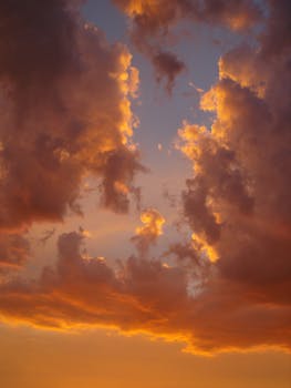 Vibrant orange clouds during a striking Aragon sunset, with golden hues and a dramatic sky.