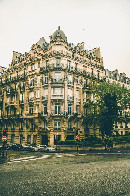 Free Elegant Parisian building under moody skies, capturing urban charm. Stock Photo
