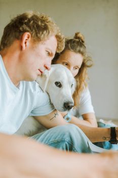 一对夫妇和他们的宠物狗在室内享受着舒适的时刻
