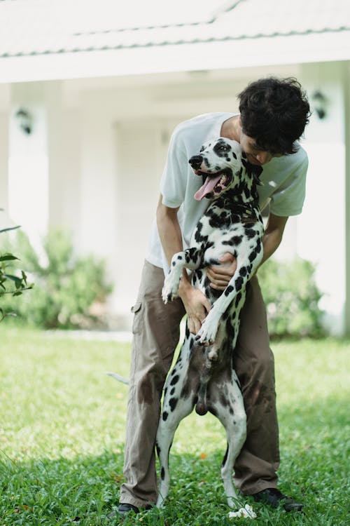 Free A Man Hugging His Dalmatian Dog  Stock Photo