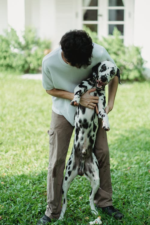 A Man Holding His Dog 