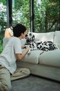 Woman in White Robe Sitting on Couch