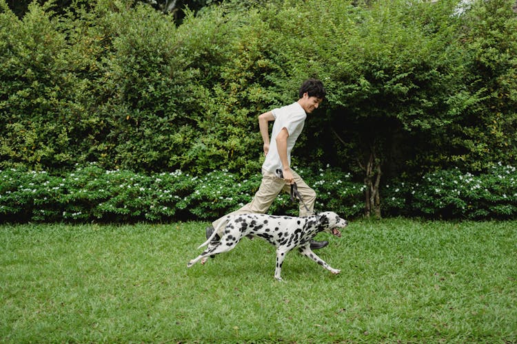 A Man Running With His Dog 