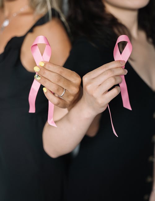 2 Women Holding Pink Ribbons