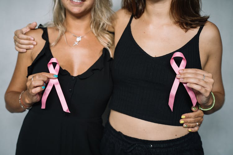 2 Women Holding Pink Ribbons