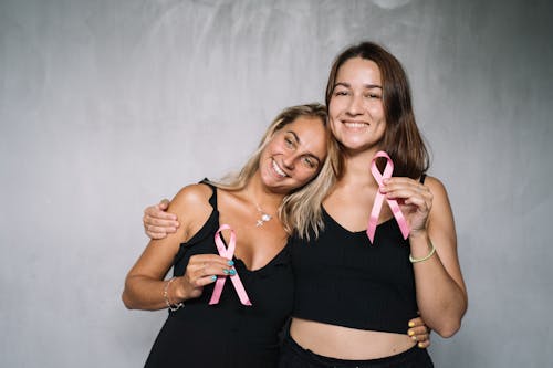 Women in Black Tank Top Holding Pink Ribbons