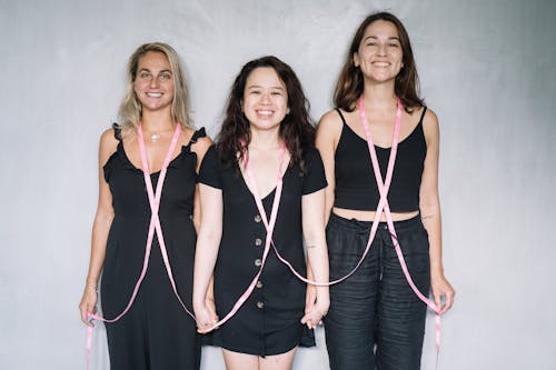 Free 3 Women in Black Tank Top Holding Hands Stock Photo