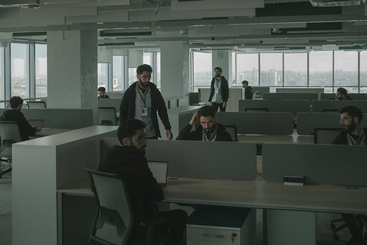 Men Looking Alike Inside An Office