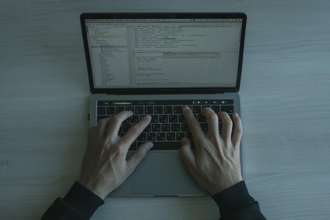 Free Hands Typing on a Laptop Keyboard Stock Photo