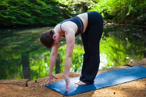 A Woman in Activewear Exercising in the Park