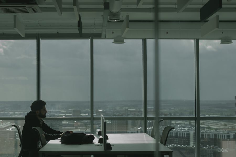 Founder working at a desk overlooking the city (placeholder image, swap for a real photo)