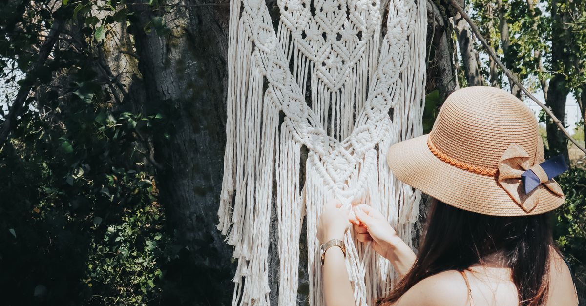 A Woman Weaving Strings by Hand · Free Stock Photo