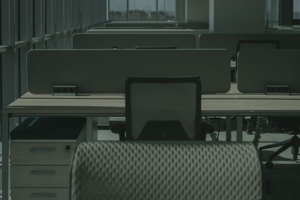 Empty open-plan office with desks and chairs after hours, ready for a weekend office move