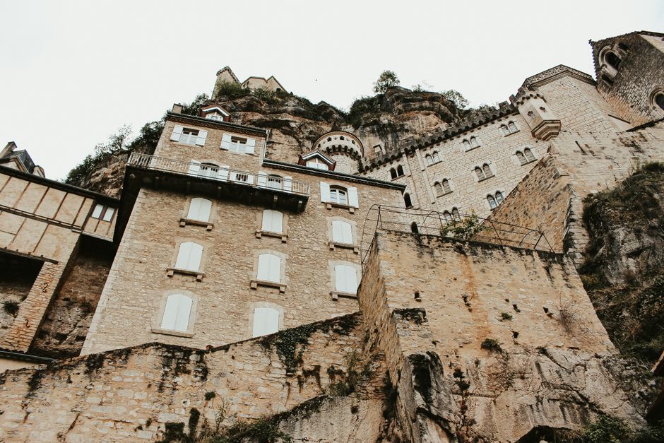 Explore the stunning cliffside architecture of Rocamadour village in France, a blend of medieval and gothic styles.