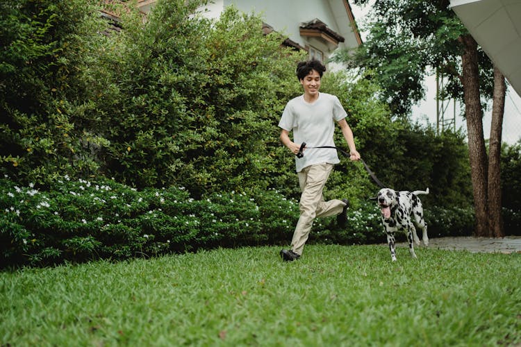 A Man Running With His Dog