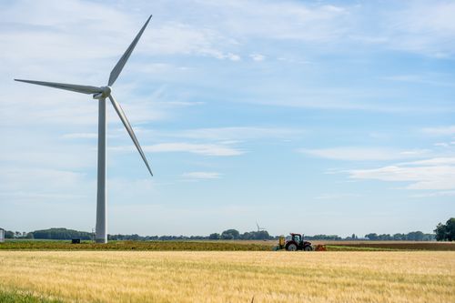 Free A tranquil view of a wind turbine amid a vast farm landscape in Harlingen, Netherlands. Stock Photo