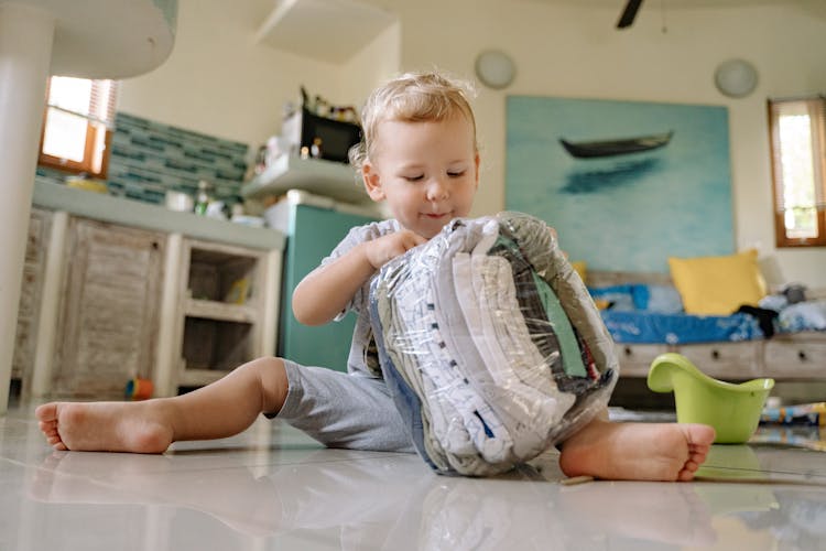 Toddler Playing With Clothes Plastic Bag