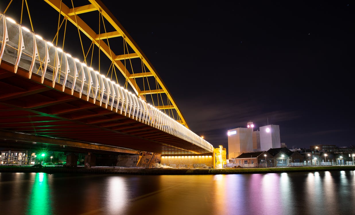 White Bridge over Body of Water during Night Time