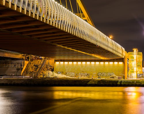 Iluminated Bridge over River during Night Time